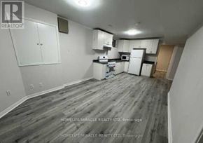 Brampton (Snelgrove) apartment for rent - A kitchen area with white cabinets and a microwave above the stove.