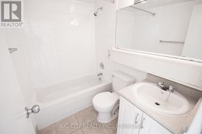 Toronto (Playter Estates-Danforth) condo for rent - A white bathroom with a toilet, sink and bathtub.