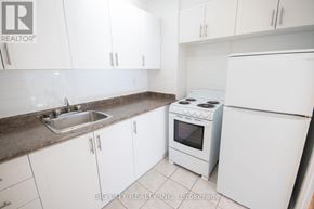 Toronto (Playter Estates-Danforth) condo for rent - A white kitchen with a sink and stove.
