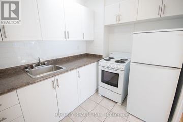 Toronto (Playter Estates-Danforth) condo for rent - A white kitchen with a sink and stove.