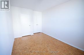 Toronto (Playter Estates-Danforth) condo for rent - A room with two doors and a wooden floor.