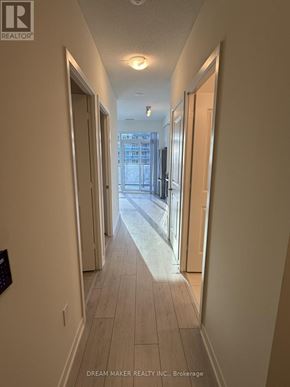 Toronto (Mimico) condo for rent - A hallway with a sign that says "Dream Maker Realty Inc. Brokerage".