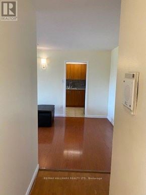 Toronto (Henry Farm) condo for rent - A hallway with a bench and a door at the end.
