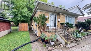 Toronto (Bathurst Manor) apartment for rent - A house with a front yard and a hose.