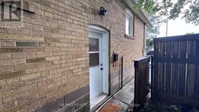 Toronto (Bathurst Manor) apartment for rent - A small house with a white door and a wooden fence.