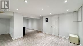 Toronto (Bathurst Manor) apartment for rent - A spacious room with a white ceiling and a large window.