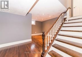 Oshawa (Lakeview) apartment for rent - A wooden staircase with white railings leads up to a white door.