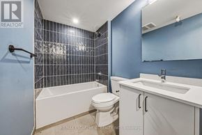 Hamilton (Corktown) multi-family for rent - A bathroom with blue walls and white fixtures.
