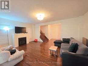 Pickering (Duffin Heights) apartment for rent - A living room with a fireplace and a couch.