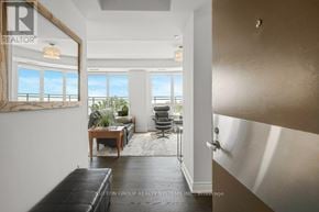 Oakville (Br Bronte) condo for rent - A living room with a view of the ocean through the windows.