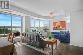 Oakville (Br Bronte) condo for rent - A well-lit room with a large bed and a sofa.