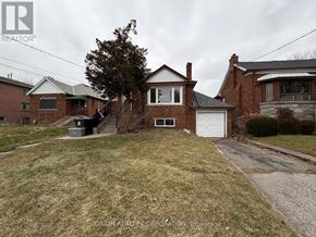 Toronto (Yorkdale-Glen Park) apartment for rent - A house with a driveway in front of it.