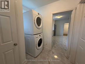 Toronto (Yorkdale-Glen Park) apartment for rent - A laundry room with a washer and dryer stacked on top of each other.