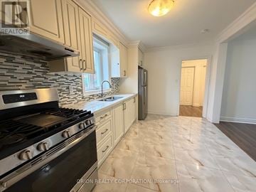 Toronto (Yorkdale-Glen Park) apartment for rent - A kitchen with a black stove top oven and a tiled backsplash.