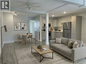 Hamilton apartment for rent - A well-lit, modern living room with a grey sofa and a coffee table.
