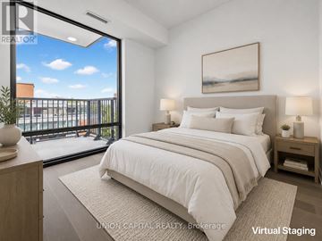 Toronto (Forest Hill South) condo for rent - A bedroom with a large bed and a view of the outside through a glass door.