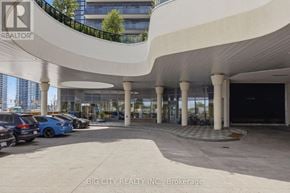 Mississauga (Hurontario) condo for rent - A parking lot with cars and a building in the background.