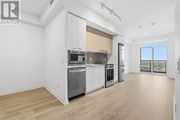 Mississauga (Hurontario) condo for rent - A spacious kitchen with white cabinets and stainless steel appliances.
