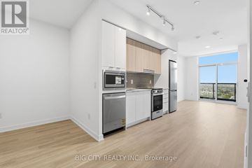Mississauga (Hurontario) condo for rent - A spacious kitchen with white appliances and wooden flooring.