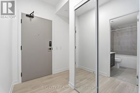 Mississauga (Hurontario) condo for rent - A white door with a black handle and a black lock.