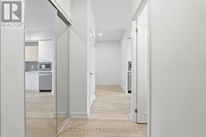 Mississauga (Hurontario) condo for rent - A white hallway with a door on the left and a door on the right.