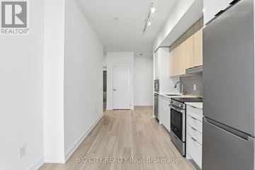 Mississauga (Hurontario) condo for rent - A modern kitchen with a refrigerator, oven, and stove top.