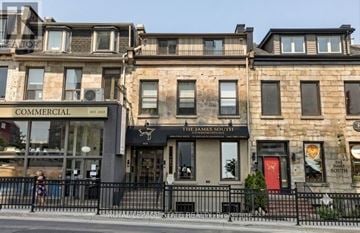 Hamilton (Durand) apartment for rent - A building with a sign that says "Commercial" is in front of another building.