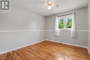 Champlain apartment for rent - A room with wooden flooring and a window with white curtains.