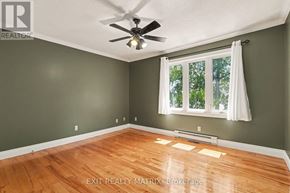 Champlain apartment for rent - A room with a ceiling fan and a window with white curtains.