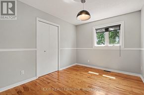 Champlain apartment for rent - A room with a wooden floor and a window with a view of trees outside.