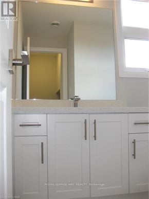 Niagara Falls (Morrison) townhouse for rent - A white bathroom with a sink and cabinets.