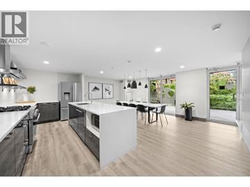 Vancouver apartment for rent - A modern kitchen with a dining area and a large window.