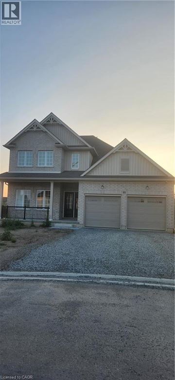 Welland apartment for rent - A house with a garage and a driveway in front.