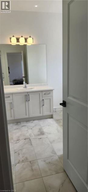 Welland apartment for rent - A bathroom with a white vanity and a mirror above it.