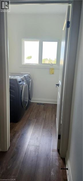 Welland apartment for rent - A room with a window and a wooden floor.