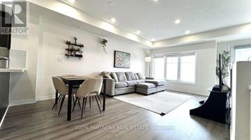Toronto (L'amoreaux) townhouse for rent - A well-lit living room with a dining table and a couch.