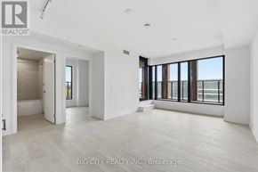 Toronto (Thorncliffe Park) condo for rent - A spacious room with a view of the city through large windows.