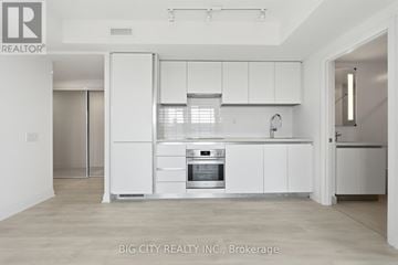 Toronto (Thorncliffe Park) condo for rent - A white kitchen with a stove top oven and a sink.