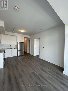 Vaughan (Beverley Glen) condo for rent - A spacious kitchen with white cabinets and a grey floor.