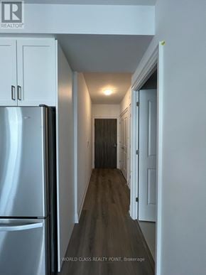 Vaughan (Beverley Glen) condo for rent - A long hallway with a refrigerator on the left.