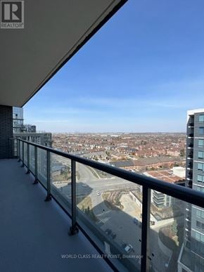 Vaughan (Beverley Glen) condo for rent - A balcony with a glass railing overlooks a cityscape.