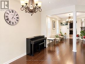 Oakville (Jc Joshua Creek) apartment for rent - A living room with a piano and a chandelier.