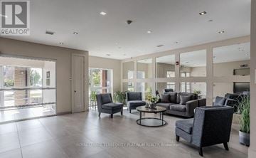 Burlington (Tansley) house for rent - A spacious living room with a large grey sofa and a glass door leading to a balcony.