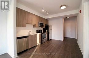Burlington (Tansley) house for rent - A kitchen with wooden cabinets and stainless steel appliances.