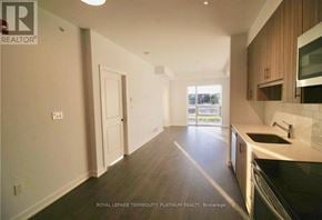 Burlington (Tansley) house for rent - A kitchen with white walls and wooden cabinets.