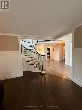 Burlington (Headon) apartment for rent - A wooden staircase with a metal railing leads to a second floor.