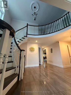 Burlington (Headon) apartment for rent - A staircase with a black railing and white balusters leads to a second floor.