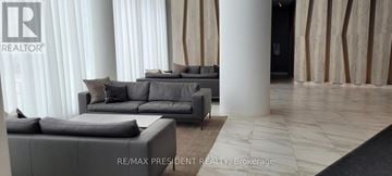 Mississauga (City Centre) condo for rent - A living room with grey couches and a black rug.