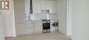 Mississauga (City Centre) condo for rent - A white kitchen with a stainless steel oven and microwave.