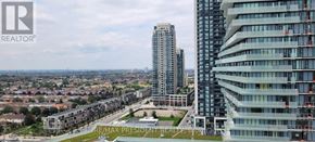 Mississauga (City Centre) condo for rent - A cityscape with apartment buildings and a green park area.